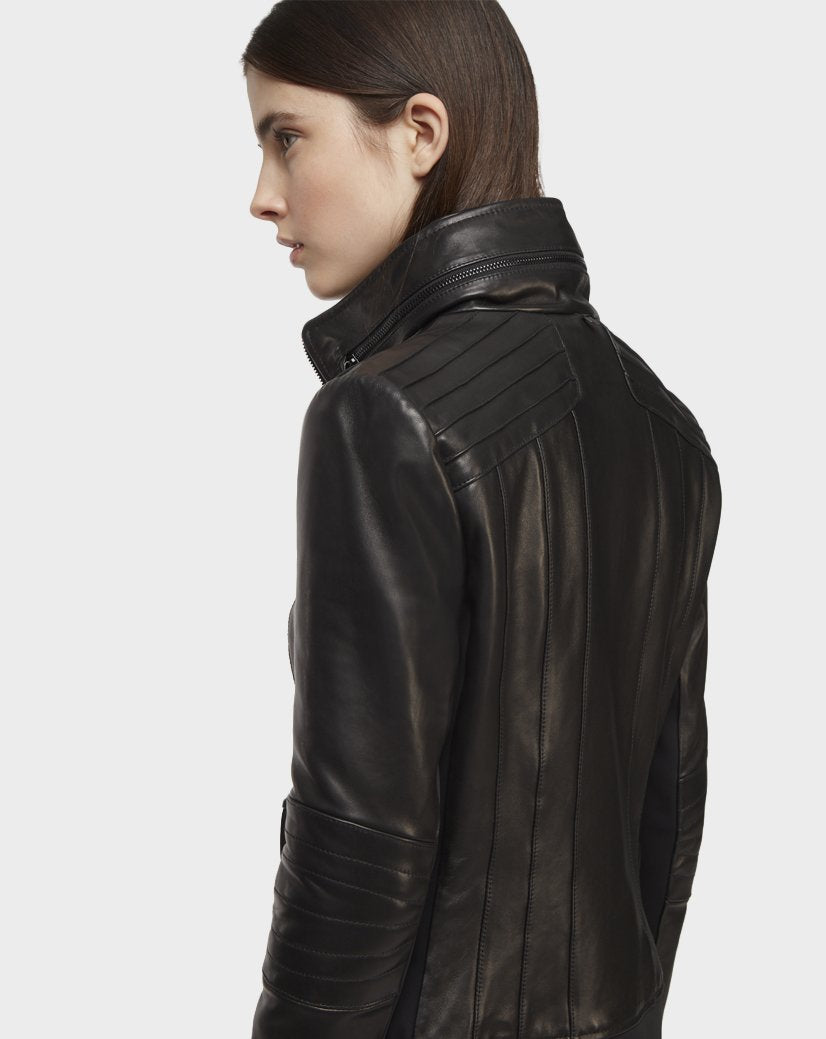 A person with straight brown hair is shown in profile against a plain white background, wearing the Rudsak PRESLEY - CA EN 8119029 BLACK lamb leather biker jacket featuring quilted moto details on the shoulders and sleeves.