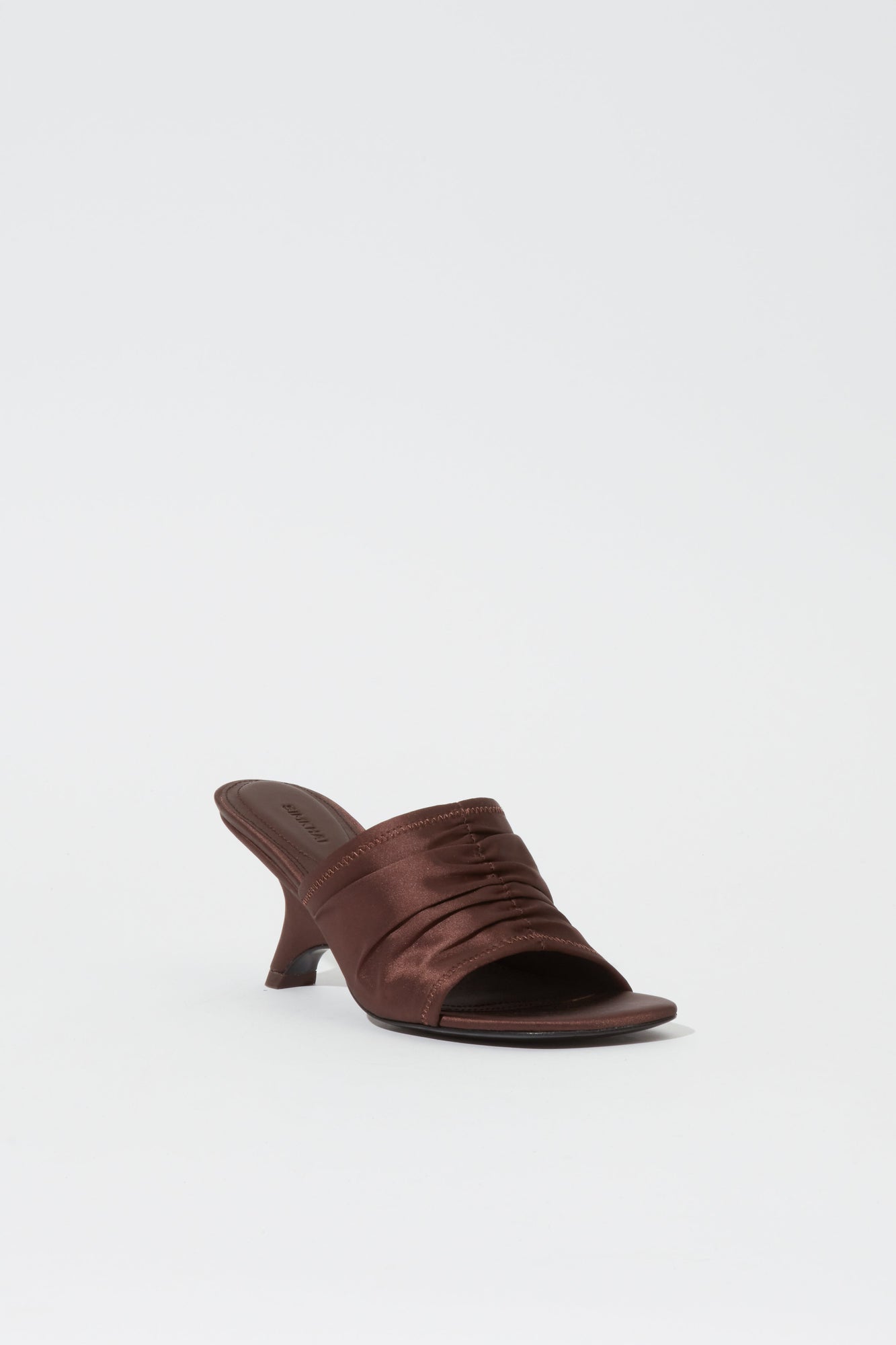 Dark brown satin mule with ruched upper detail and curved heel.