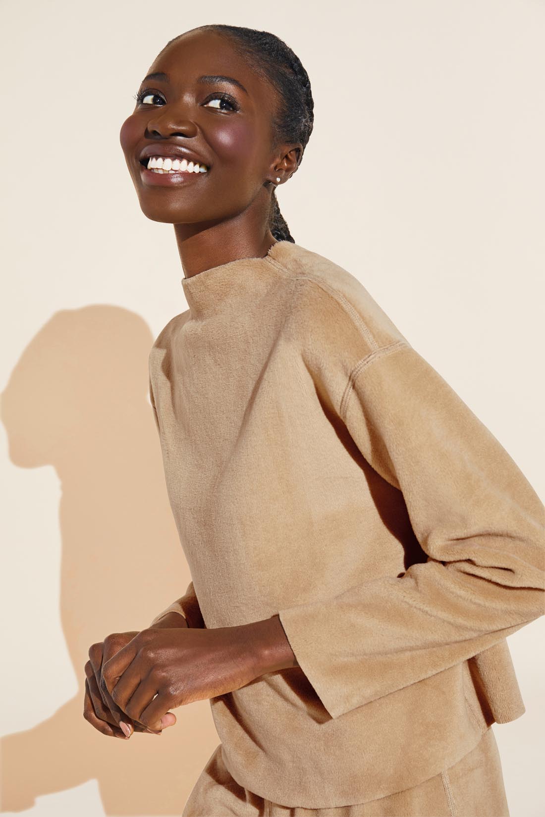 Model wears Reversible Plush Funnel Neck Top in mocha.