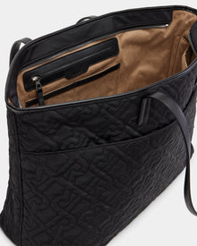 The LIVORNO - L325007 Black by Rudsak is a black quilted monogram tote with large embossed letters, brown suede lining, a spacious interior, a zippered pocket, and slip pockets—a luxurious carryall.