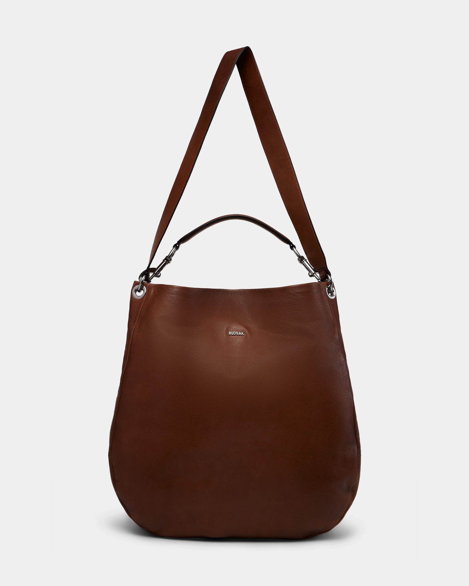 The Rudsak VIKA - 8325036 Mocha is a large women’s brown leather hobo shoulder bag with a wide strap, small top handle, silver-tone hardware, and subtle front logo—an ideal stylish everyday accessory shown on a plain white background.