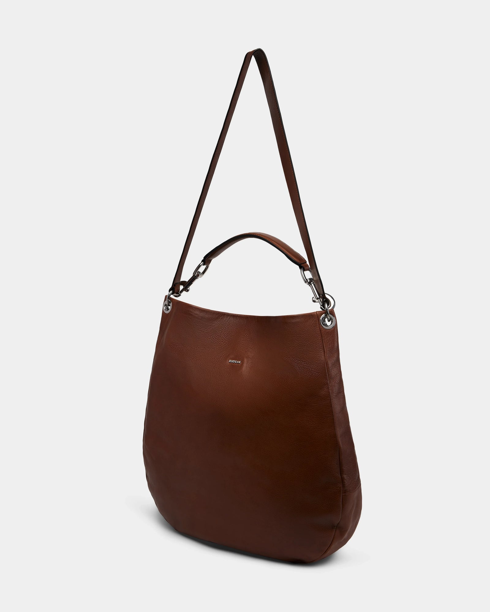 The Rudsak VIKA - 8325036 Mocha is a women’s brown hobo shoulder bag with silver hardware, short handle, and long adjustable strap, shown against a plain white background.