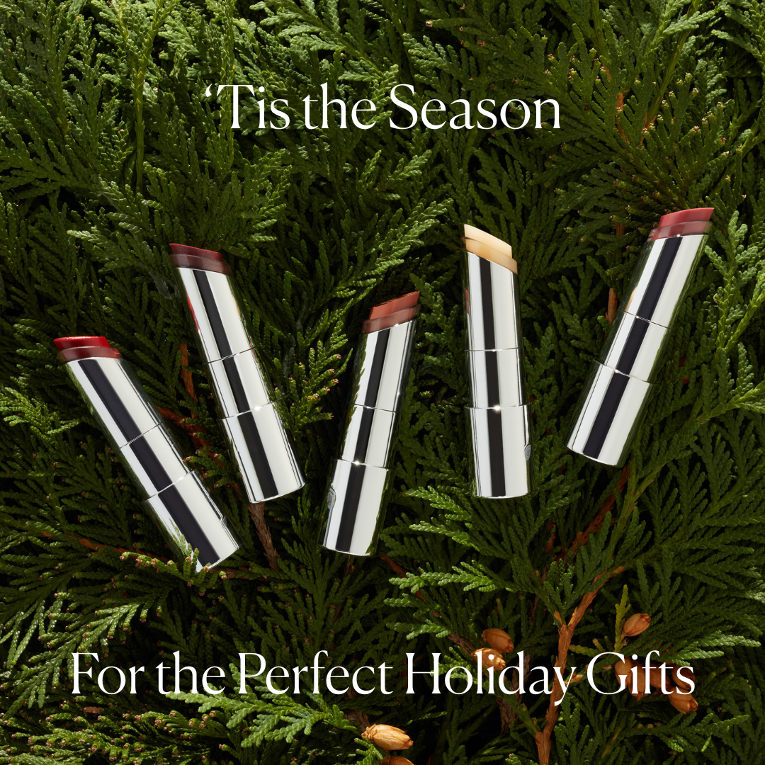 lipstick tubes on a green fir background