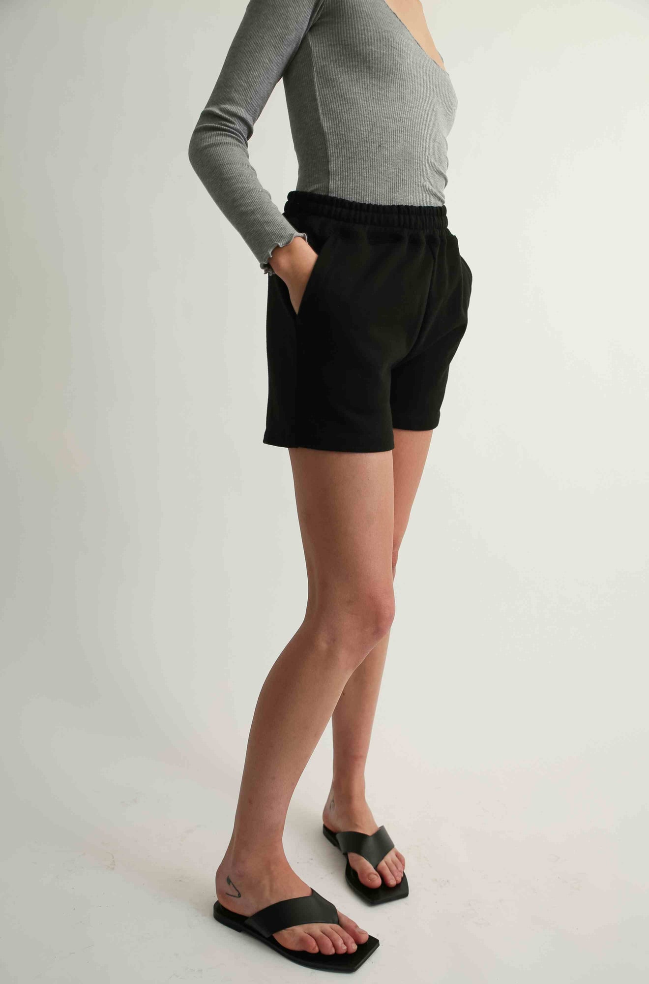 Woman wearing black sweatshorts