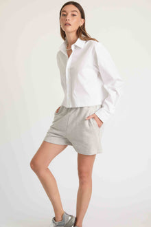 Woman wearing grey sweatshorts