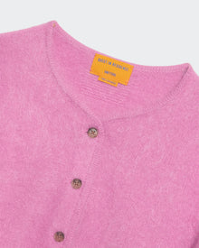 Close-up of a soft rose pink brushed cashmere crew-neck cardigan with button details and rib trim