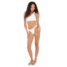 Full-body shot of model wearing the Are You Am I Aimi Bikini Top in white terry, styled with matching bottoms, featuring a one-shoulder knotted strap. **white