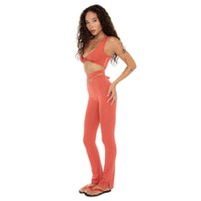 Three-quarter view of Alda Legging in cayenne highlighting second-skin fit and flared hem. **cayenne