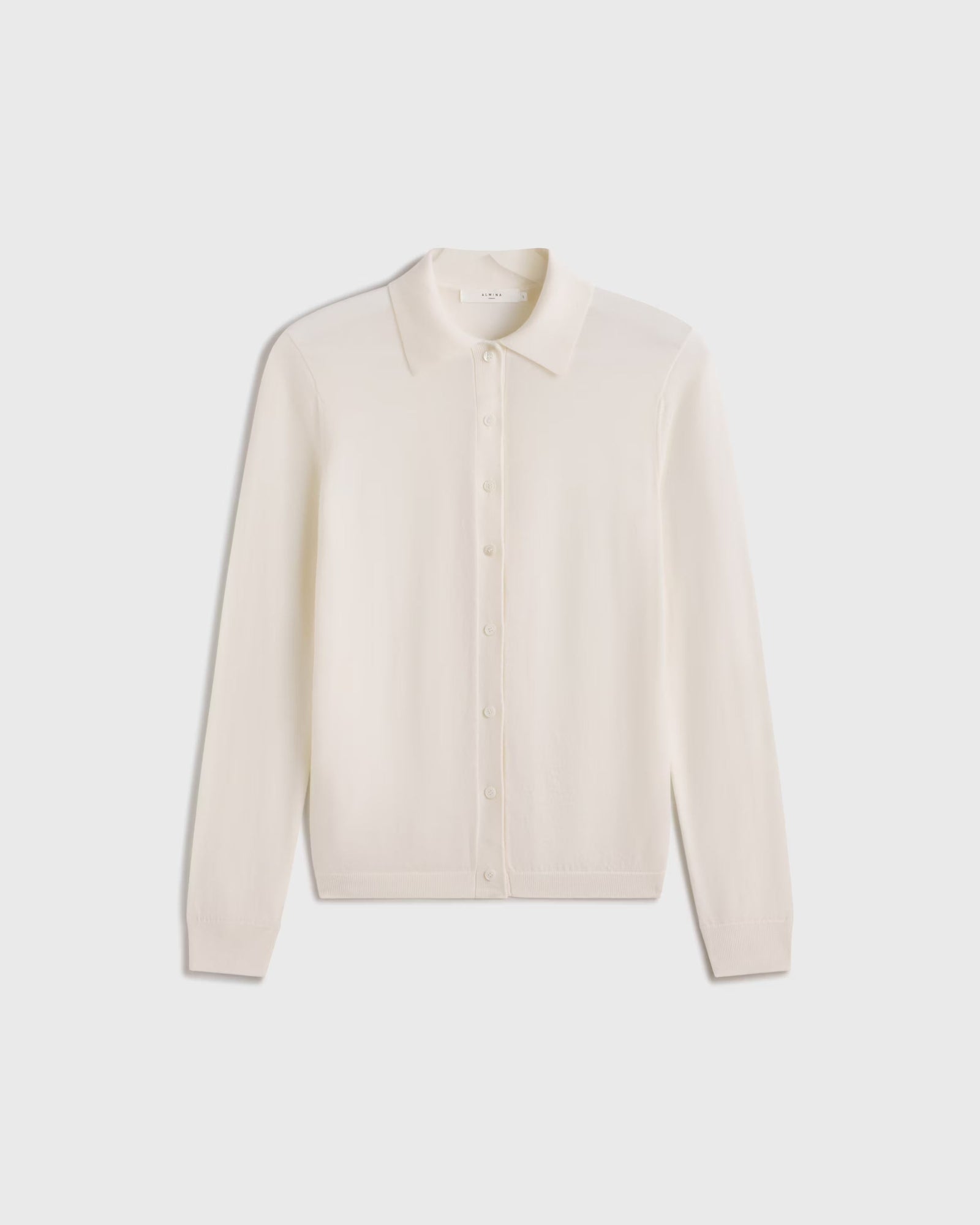 Beige long-sleeve shirt on a light gray background