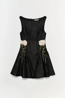 Black jacquard mini dress with white and gold floral embroidery at waist, sleeveless with boat neckline.