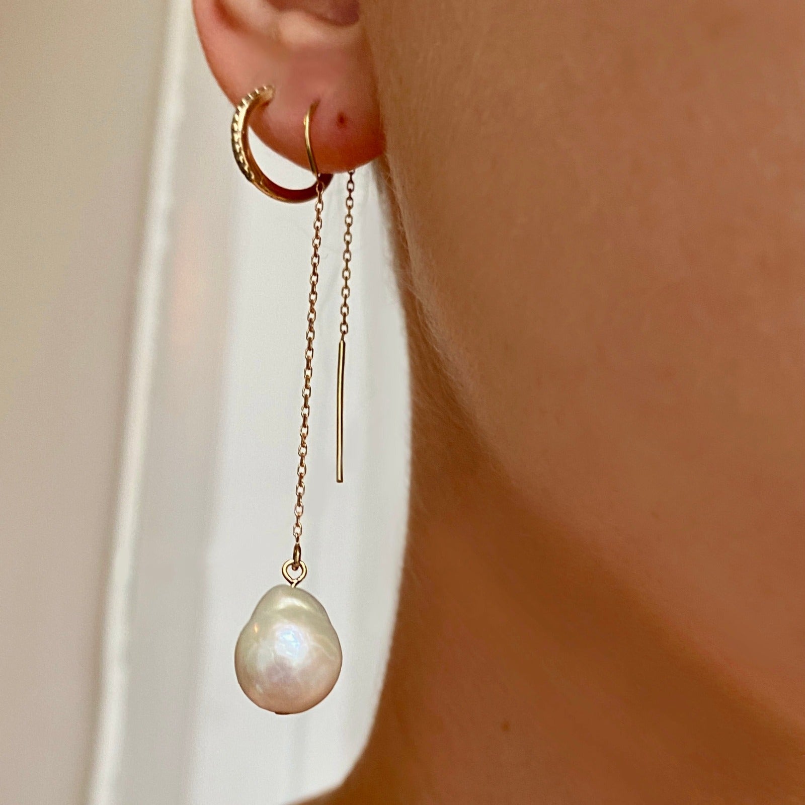 14k recycled gold Mini Baroque Pearl Ear Threader styled on a ear