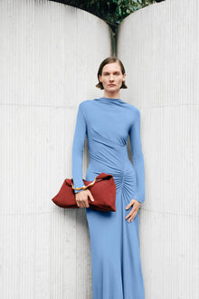 Blue long-sleeve midi dress with ruched side detailing and draped neckline.
