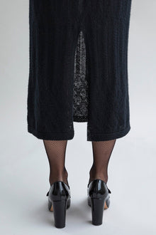 Detail of the center back slit as seen on the Margot Dress in black. 