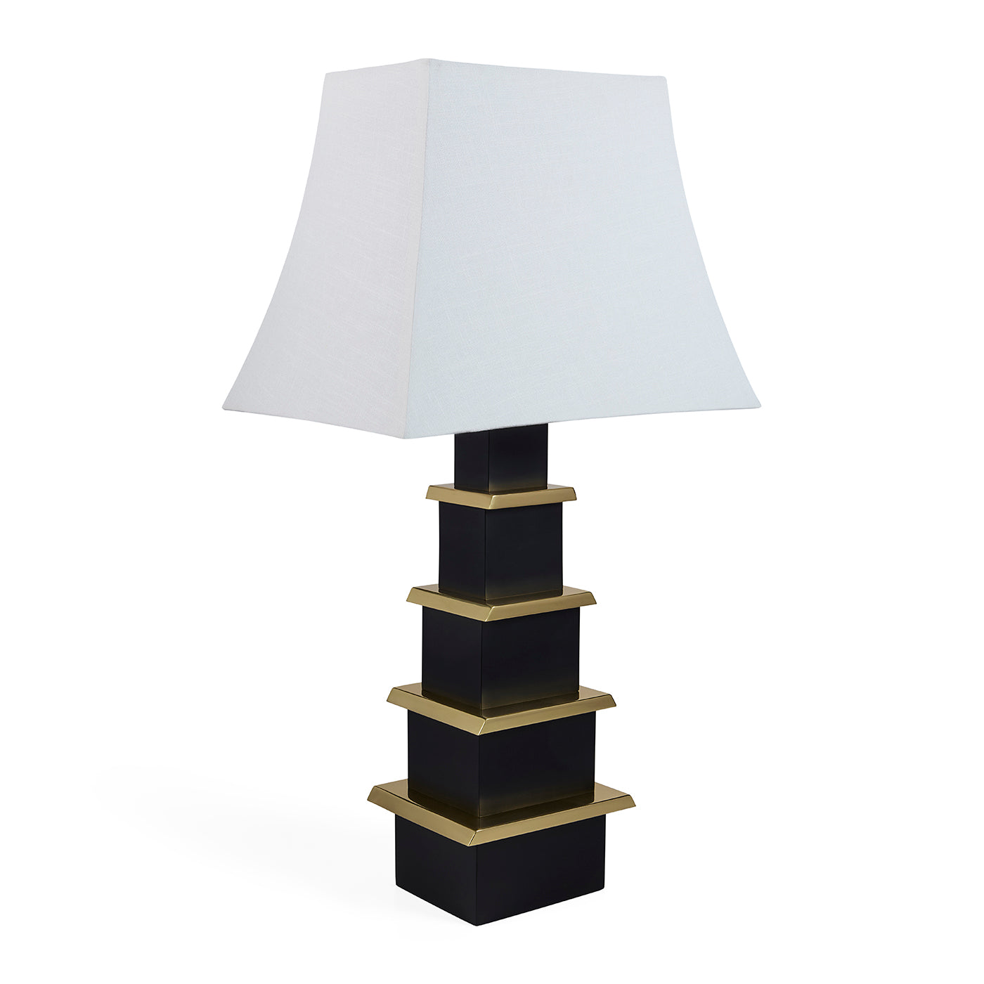 Table lamp with a black and gold base and white shade on a white background
