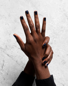 Overhead view of two hands with nails painted black