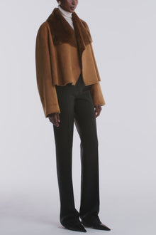 Model is wearing the Nour Hammour Cascade Draped Shearling Jacket Marigold - Video