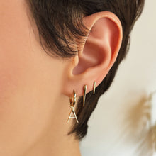 14k recycled gold Small Quill Spike Stud styled on a ear with the medium quill spike and letter 