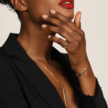 14k recycled gold Quill Bypass Ring with diamond layered with a ripple ring and Quill Cuff on model