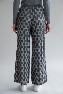 Back view of Zoe Trousers, highlighting the graphic-checked pattern in the darker colorway.